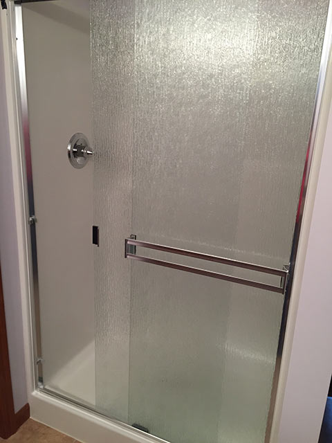 Installation of a frameless door on new shower.