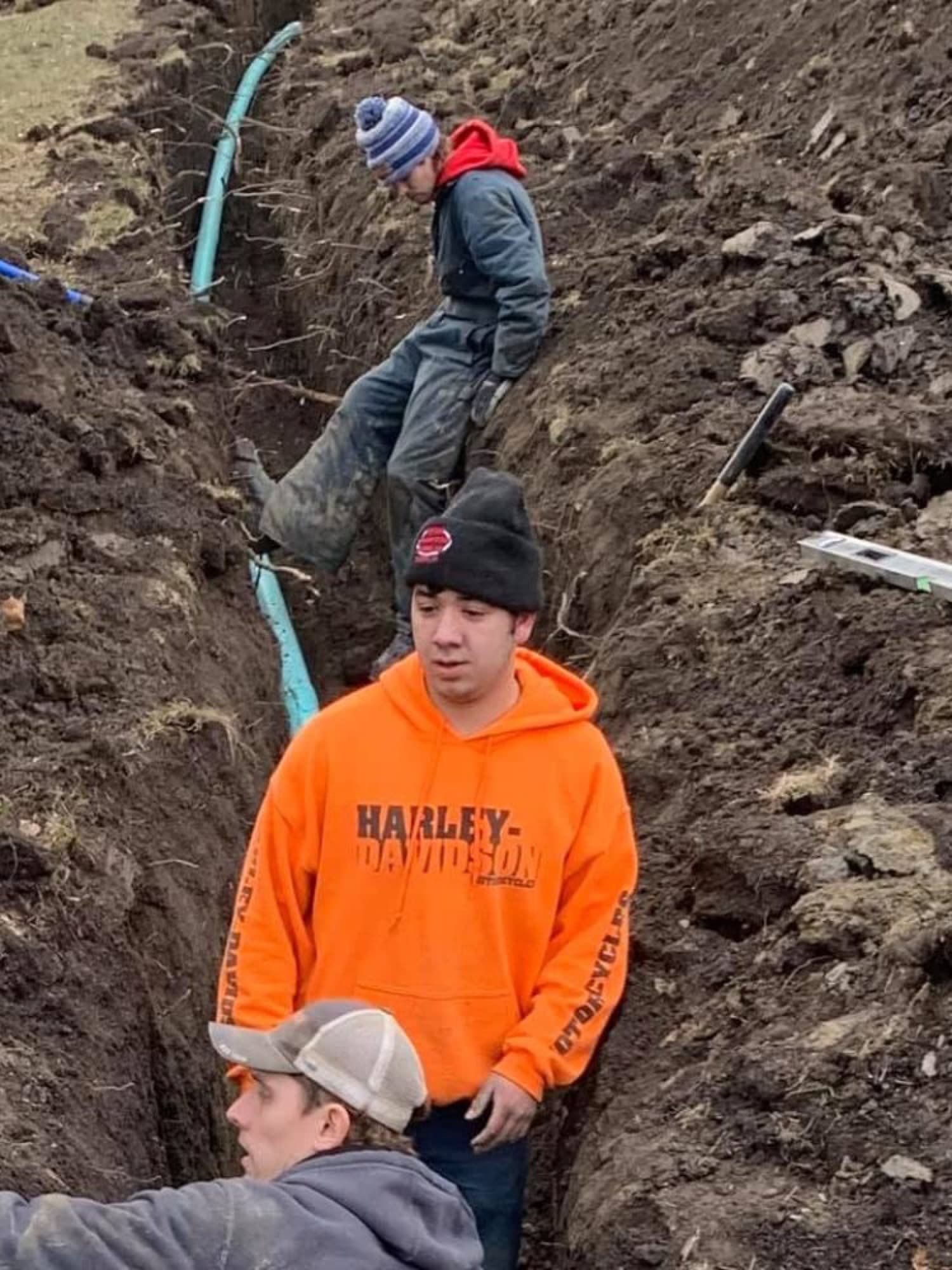 Andrews Plumbing crew working in a deep sewer trench