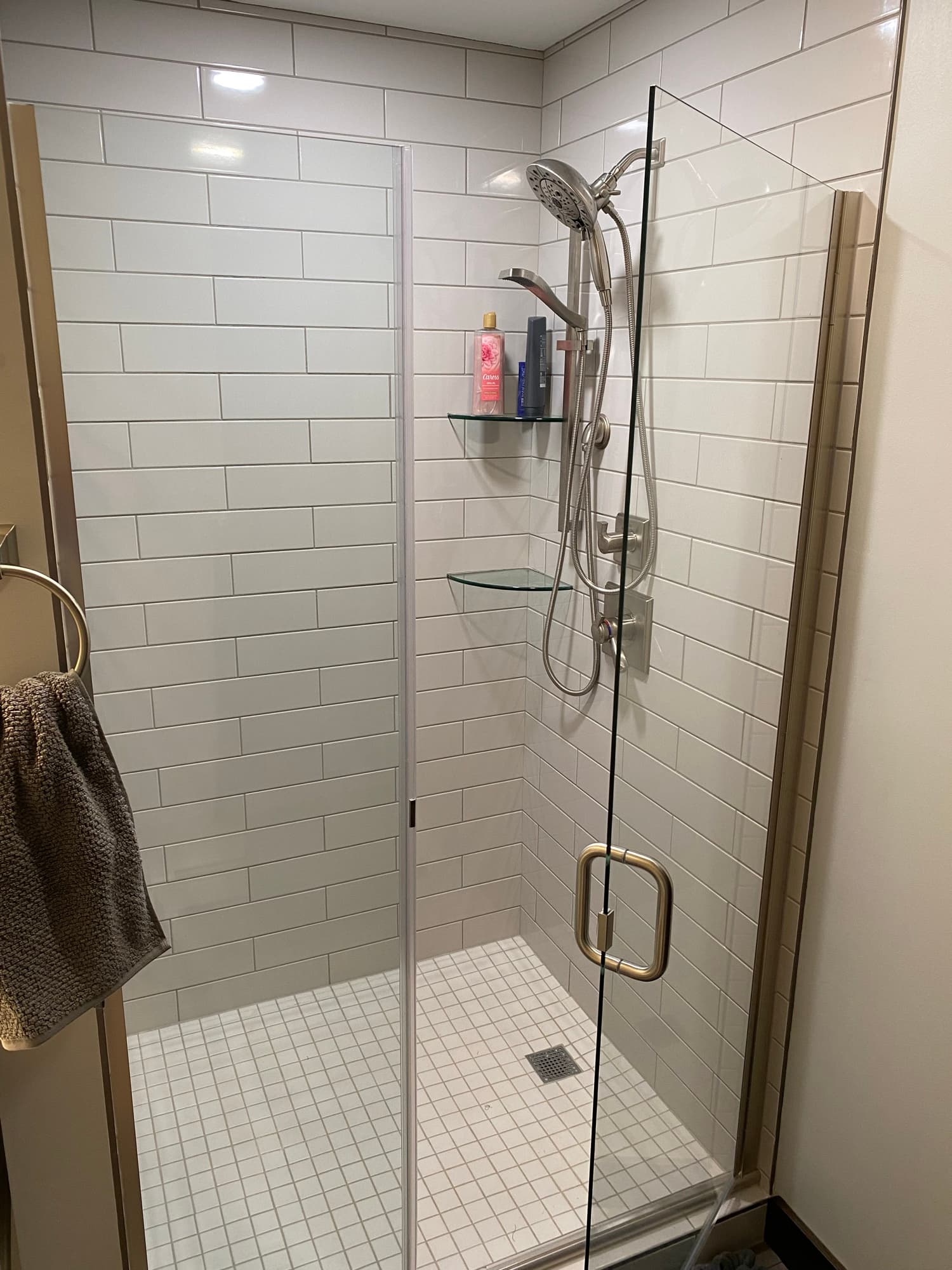 Tiled walk-in shower with new fixtures from a bathroom remodel